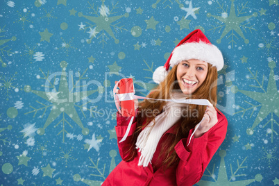 Composite image of festive redhead opening a gift