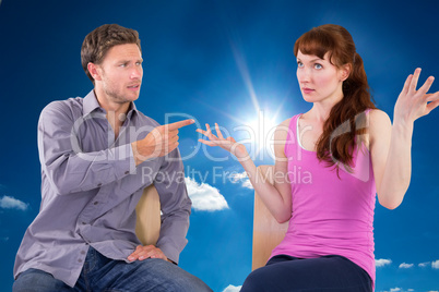 Composite image of sitting couple having an argument