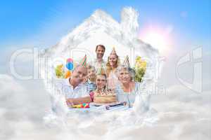 Composite image of cheeful family smiling at camera at birthday