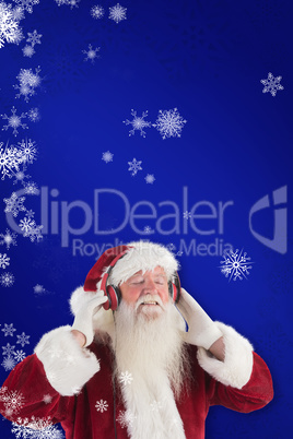 Composite image of santa claus enjoys some music