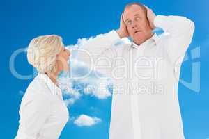 Composite image of angry older couple arguing with each other