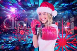 Composite image of festive blonde punching with boxing gloves