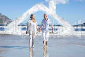 Composite image of happy couple walking barefoot on the beach