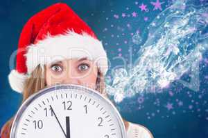 Composite image of festive blonde showing a clock
