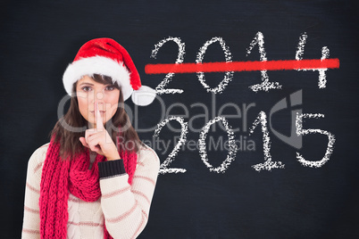 Composite image of festive brunette keeping a secret