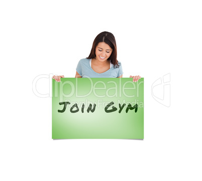 Composite image of gorgeous woman holding a  board