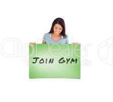 Composite image of gorgeous woman holding a  board