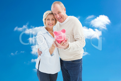 Composite image of happy mature couple smiling at camera showing