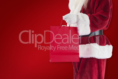 Composite image of santa carries red gift bag