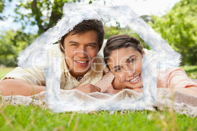 Composite image of two friends lying together on a blanket while