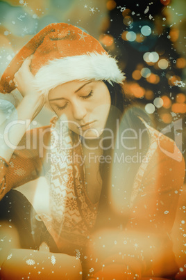 Composite image of festive brunette feeling sad at christmas