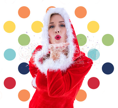 Composite image of festive blonde blowing a kiss