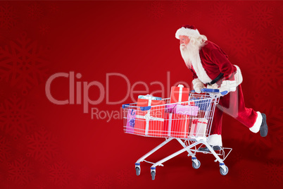 Composite image of santa pushes a shopping cart