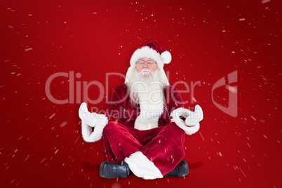 Composite image of santa claus sits and meditates