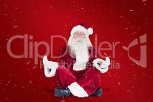 Composite image of santa claus sits and meditates