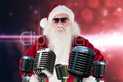 Composite image of santa claus wears black sunglasses