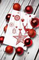 Composite image of hanging red christmas decorations