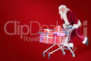 Composite image of santa rides on a shopping cart