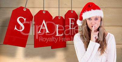 Composite image of festive blonde keeping a secret