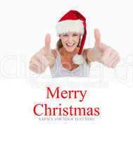 Composite image of woman with the thumbs up and a christmas hat