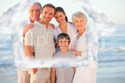 Composite image of portrait of a smiling family at the beach
