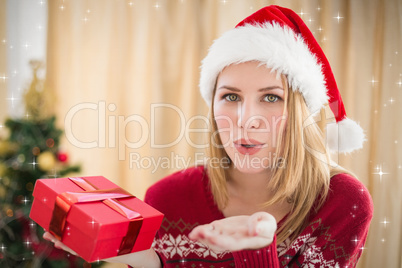 Composite image of pretty blonde in winter fashion blowing over