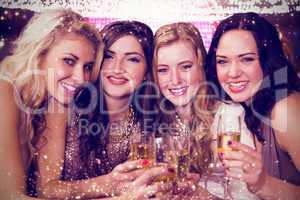 Composite image of friends drinking champagne