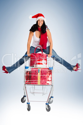 Woman jumping with shopping trolley