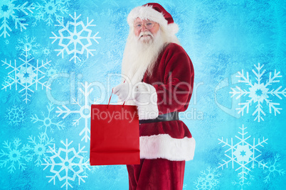 Composite image of santa carries red gift bag