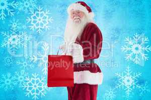 Composite image of santa carries red gift bag