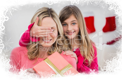 Composite image of little girl hiding gift from mother