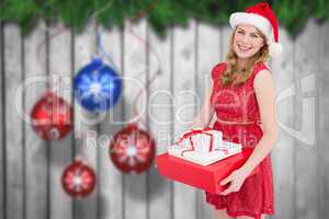 Composite image of smiling woman with present