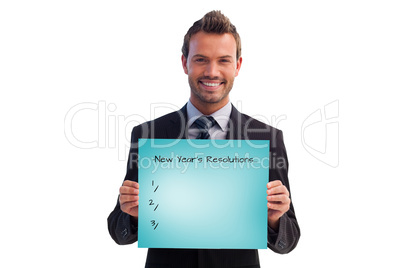 Composite image of smiling businessman holding a white card