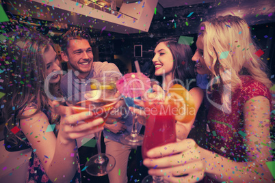 Composite image of happy friends having a drink together