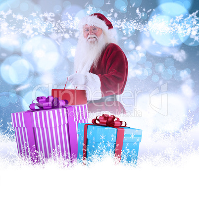 Composite image of santa carries red gift bag