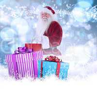 Composite image of santa carries red gift bag