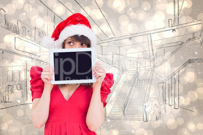 Composite image of festive brunette holding a tablet pc