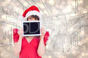 Composite image of festive brunette holding a tablet pc