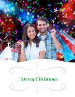 Composite image of happy couple with shopping bags