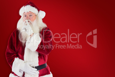 Composite image of santa asking for quiet to camera