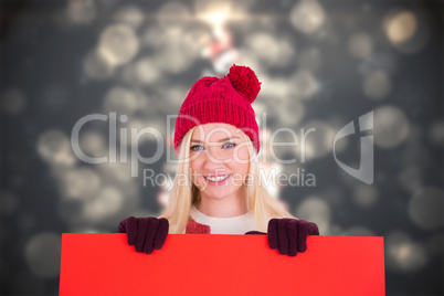 Composite image of festive blonde showing a red poster