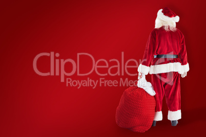 Composite image of santa carrying sack of gifts Composite image of santa carrying sack of gifts