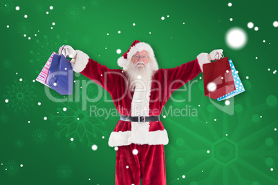 Composite image of santa holds some bags for chistmas