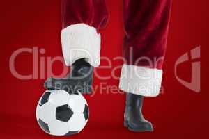 Composite image of santa claus is playing soccer