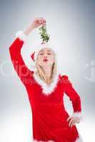 Festive blonde holding some mistletoe