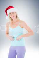 Festive fit blonde pinching her stomach