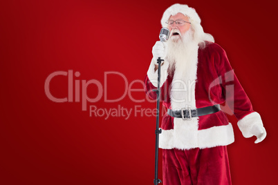 Composite image of santa sings like a superstar
