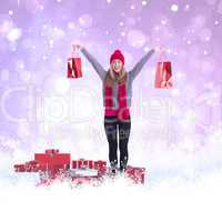 Composite image of festive blonde holding shopping bags