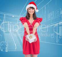 Composite image of festive brunette giving a gift