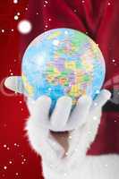 Composite image of santa has a globe in his hand